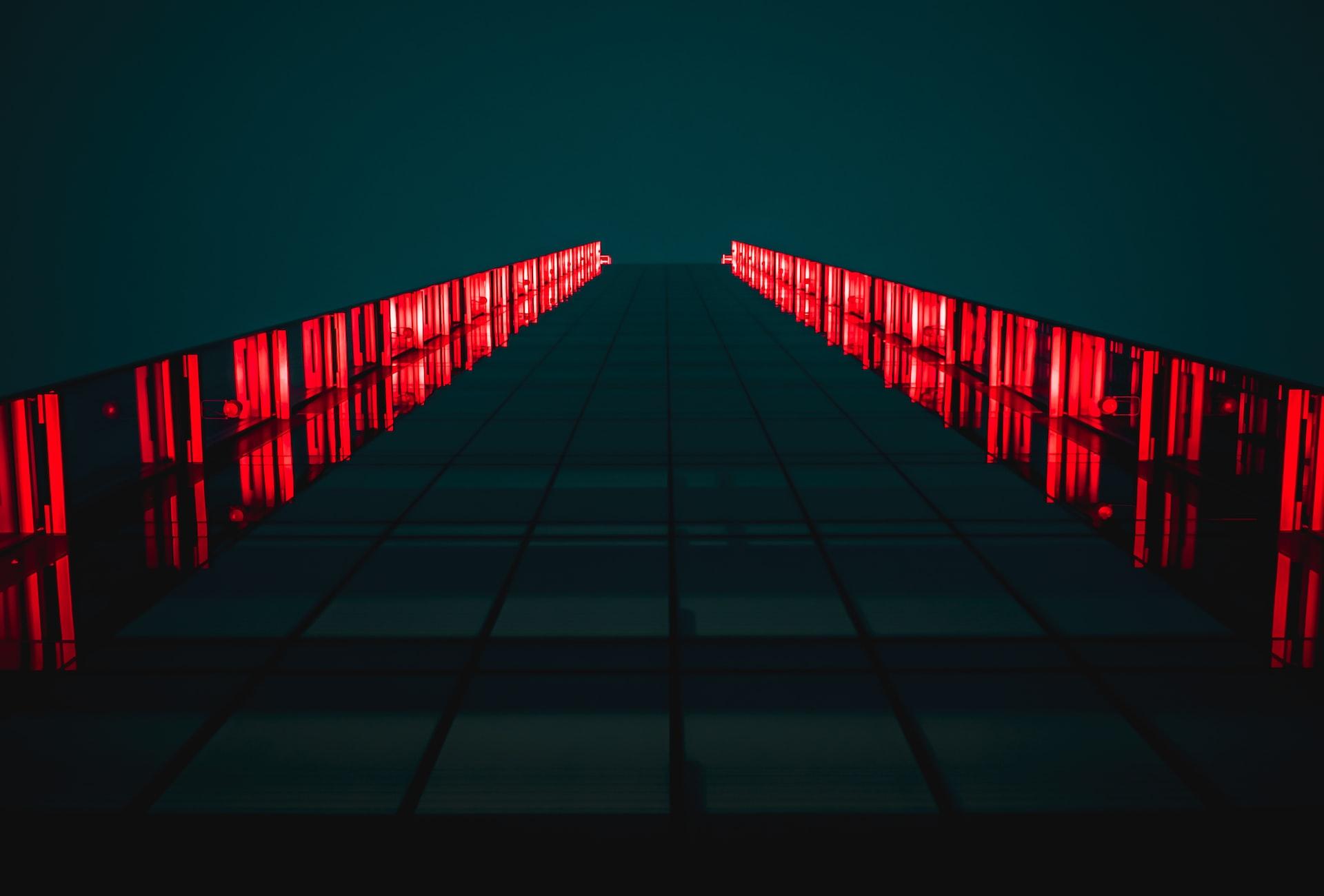 black pathway between red LED light rails